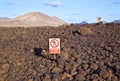 Keep-off sign in volcanic landscape of the Timanfaya National Park in Lanzarote