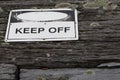 Keep off warning sign over old weathered rustic wooden textured Royalty Free Stock Photo