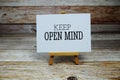 Keep Open Mind Quote text on paper card with easel on wooden background Royalty Free Stock Photo