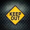 Keep Out Grunge Yellow Warning Sign on Chainlink Fence Royalty Free Stock Photo