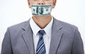 Keep it quiet Or else...Concept shot of a businessman with money covering his mouth.