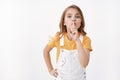 Keep quiet please. Determined obedient cute blond girl child showing hush sign, shushing asking silence, hold finger on