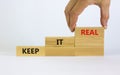 Keep it real symbol. Businessman placing a blocks with word `keep` on top of a blocks tower with words `keep it real`. Beautif