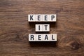 Keep it real - word concept on building blocks, text