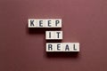 Keep it real - word concept on cubes