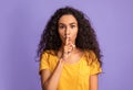 Keep silence. Serious young woman showing shhh sign at camera Royalty Free Stock Photo