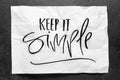 Keep it simple. Lettering on crumpled white paper. Handwritten text. Inspirational quotes. Royalty Free Stock Photo