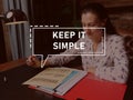 KEEP IT SIMPLE phrase on the screen. Broker analyzing market research results Royalty Free Stock Photo
