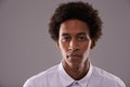 Keep it simple. Studio shot of a young man posing against a gray background.