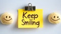Keep Smiling Note With Clipboard Between Two Smiley Faces Isolated On White Background Royalty Free Stock Photo