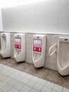 Keep social distancing in public bathrooms to use urinal Royalty Free Stock Photo