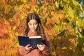 Keep studying. Small girl read book on autumn day. Small child enjoy reading autumn foliage background. Little child