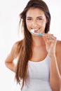 Keep them pearly white. A gorgeous young brunette brushing her teeth in the morning.