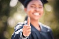 Keep up the good work. Closeup shot of a young woman showing thumbs up on graduation day. Royalty Free Stock Photo