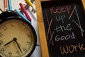 Keep up the good work on phrase colorful handwritten on chalkboard, alarm clock with motivation and education concepts Royalty Free Stock Photo