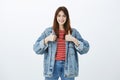 Keep up, you are doing great. Satisfied confident joyful woman in streetstyle denim jacket, showing thumbs up and