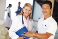 Keep us away Eat an apple. two medical professionals smiling at the camera. Royalty Free Stock Photo