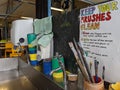 Keep your brushes clean sign with artists paint brushes washing station