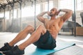 Keep your core engaged. a young man completing crunches.