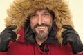Keep your head snug in cosy hood. Happy man wear parka hood. Mature man smile in faux fur hood. Fashion trends for