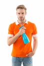 Keep your house dust-free. Handsome man hold hygiene spray bottle. Disinfectants and antibacterials in home hygiene