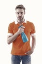 Keep your house dust-free. Handsome man hold hygiene spray bottle. Disinfectants and antibacterials in home hygiene