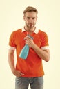 Keep your house dust-free. Handsome man hold hygiene spray bottle. Disinfectants and antibacterials in home hygiene
