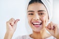 Keep your smile shining bright. Portrait of a beautiful young woman flossing her teeth in the bathroom at home. Royalty Free Stock Photo