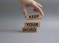 Keep your word symbol. Wooden blocks with words Keep your word. Beautiful grey background. Businessman hand. Business and Keep