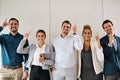 Keeping business booming. Portrait of a group of businesspeople standing in an office.