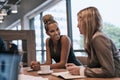 Keeping business booming together. two businesswomen having a meeting in an office.