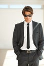 Keeping business cool. Portrait of a handsome young businessman in a suit and wearing sunglasses.