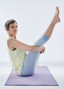 Keeping her core strong. Full length portrait of an attractive woman stretching before yoga.