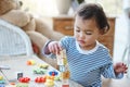 Keeping her little hands busy. an adorable little girl playing with her toys at home. Royalty Free Stock Photo