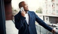 Keeping his career right on track. a handsome young businessman talking on a cellphone outside his office. Royalty Free Stock Photo