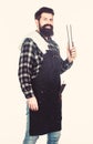 Keeping his hand far from flame. Bearded man holding barbecue tongs in hands. Grill cook using kitchen tongs. Chef