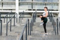 Keeping those muscles flexible. Young male runner athlete training and exercising outdoors in the city. Warm up firstly Royalty Free Stock Photo