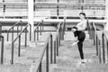 Keeping those muscles flexible. Young male runner athlete training and exercising outdoors in the city. Warm up firstly Royalty Free Stock Photo