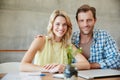 Keeping our home finances in check. Portrait of a happy couple doing their budgeting together at home. Royalty Free Stock Photo