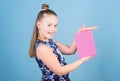 Keeping secrets here. Keeping her secrets in diary. Child cute girl hold notepad or diary blue background. Childhood