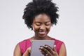 Keeping tabs on everything thats trending. Studio shot of a young woman using a digital tablet against a grey background