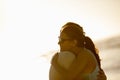 Keeping their love alive. a happy young couple hugging outdoors with a bright sky behind. Royalty Free Stock Photo