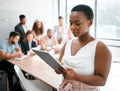 Keeping track of the minutes via technology. an attractive young businesswoman attending a meeting in the boardroom with Royalty Free Stock Photo