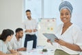 Keeping track of what happens in the meeting. Cropped portrait of an attractive young businesswoman using her tablet Royalty Free Stock Photo