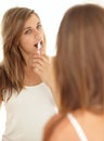 Keeping up with oral hygiene. A beautiful young woman brushing her teeth. Royalty Free Stock Photo