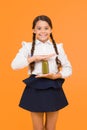 Keeping you energetic. Happy energetic schoolchild holding juice bottle on yellow background. Little girl with long hair