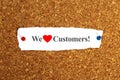 we love customers word on paper Royalty Free Stock Photo