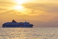 Commercial ferry passing Kefalonia island at sunset Royalty Free Stock Photo