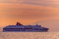 Commercial ferry passing Kefalonia island at sunset Royalty Free Stock Photo