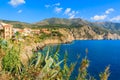 Colourful houses on cliff on coast of Kefalonia island in Assos village, Greece Royalty Free Stock Photo